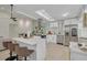 Open-concept kitchen with a quartz island, white cabinets, and stainless steel appliances, blending into the living space at 2908 Longbrooke Way, Clearwater, FL 33760