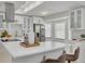 Modern kitchen with white cabinetry, stainless steel appliances, and a spacious quartz countertop island at 2908 Longbrooke Way, Clearwater, FL 33760