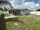 View of an expansive backyard featuring a covered patio, offering plenty of space for outdoor activities at 2927 W Henry Ave, Tampa, FL 33614