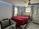 Charming bedroom with a ceiling fan, modern decor, and soft lighting creates a serene atmosphere at 2927 W Henry Ave, Tampa, FL 33614