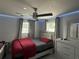 Well-lit bedroom offers contemporary decor, creating a comfortable and inviting space to unwind at 2927 W Henry Ave, Tampa, FL 33614