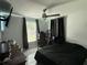 Bedroom featuring black out curtains, ceiling fan, and a full workstation with monitor at 2927 W Henry Ave, Tampa, FL 33614