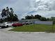 Single-story home with well-maintained lawn and several cars parked in the driveway at 2927 W Henry Ave, Tampa, FL 33614