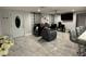 Open-concept living room with tile floors, modern decor, and a view of the kitchen counter seating at 2927 W Henry Ave, Tampa, FL 33614