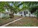 Home exterior and back yard with mature trees and foliage at 3105 N 16Th St, Tampa, FL 33605