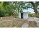 Backyard view featuring weathered shed with mature trees at 3105 N 16Th St, Tampa, FL 33605