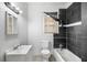 This bathroom is equipped with a sink, toilet, and tiled shower and bathtub at 3105 N 16Th St, Tampa, FL 33605