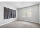This carpeted bedroom has a large window and black-out curtain that let in plenty of natural light at 3105 N 16Th St, Tampa, FL 33605