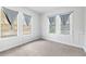 This carpeted bedroom has multiple windows with gray curtains that let in natural light at 3105 N 16Th St, Tampa, FL 33605