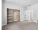 Bright bedroom features neutral carpet, an open closet, and a doorway that leads to another room at 3105 N 16Th St, Tampa, FL 33605