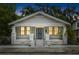 Charming single-story home featuring a fenced yard, symmetrical columns, and a cozy front porch at 3105 N 16Th St, Tampa, FL 33605