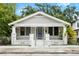 Charming single-story home featuring a fenced yard, symmetrical columns, and a cozy front porch at 3105 N 16Th St, Tampa, FL 33605