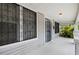 Inviting front porch with white columns and railing, featuring a view of the surrounding landscape at 3105 N 16Th St, Tampa, FL 33605