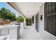 Charming front porch with white columns and railing, offering a relaxing outdoor space at 3105 N 16Th St, Tampa, FL 33605