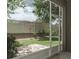 Backyard view from screened-in patio, showcasing the lush landscaping at 3298 Covered Bridge W Dr, Dunedin, FL 34698