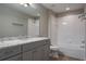 Bathroom featuring a gray vanity with a light countertop and a shower-tub combination with white tile at 3298 Covered Bridge W Dr, Dunedin, FL 34698