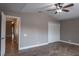 Spacious bedroom with ceiling fan, closet doors, wood-look tile flooring and neutral-toned walls at 3298 Covered Bridge W Dr, Dunedin, FL 34698