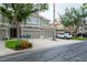 Inviting townhome exterior with multi-car garage and lush, landscaped front yard at 3298 Covered Bridge W Dr, Dunedin, FL 34698
