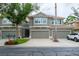 Charming two-story townhome with attached garages and well-manicured landscaping at 3298 Covered Bridge W Dr, Dunedin, FL 34698