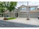 Well-maintained townhome exterior featuring an attached garage and tidy landscaping at 3298 Covered Bridge W Dr, Dunedin, FL 34698
