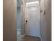 Inviting foyer with light-colored tile flooring, closet, and neutral wall paint at 3298 Covered Bridge W Dr, Dunedin, FL 34698