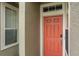 Stylish front entry door, textured wall finish, and well-lit entryway at 3298 Covered Bridge W Dr, Dunedin, FL 34698