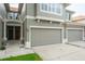 Townhome exterior showcasing a multi-car garage and a covered front entryway at 3298 Covered Bridge W Dr, Dunedin, FL 34698