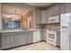 Well-lit kitchen features granite countertops, modern appliances, and tile flooring at 3298 Covered Bridge W Dr, Dunedin, FL 34698