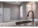Eat-in kitchen with stainless steel sink, white cabinets, and natural light at 3298 Covered Bridge W Dr, Dunedin, FL 34698