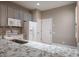 Kitchen featuring white appliances, gray cabinets, and breakfast bar seating at 3298 Covered Bridge W Dr, Dunedin, FL 34698
