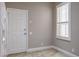 Kitchen featuring white door to the lanai and window with natural light at 3298 Covered Bridge W Dr, Dunedin, FL 34698