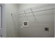 A laundry room with connections for a washing machine and dryer and white wire rack shelving at 3298 Covered Bridge W Dr, Dunedin, FL 34698