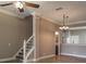 Inviting living room with staircase, ceiling fan, tile floors, and decorative lighting at 3298 Covered Bridge W Dr, Dunedin, FL 34698
