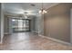 Spacious living room with tile flooring, ceiling fan, and sliding glass doors to patio at 3298 Covered Bridge W Dr, Dunedin, FL 34698