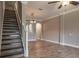 Open-concept living room featuring tile floors, staircase, and decorative lighting fixtures at 3298 Covered Bridge W Dr, Dunedin, FL 34698