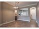 Open-concept living room with tile floors, decorative lighting, and views into the kitchen at 3298 Covered Bridge W Dr, Dunedin, FL 34698