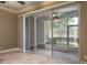 Bright room featuring sliding glass doors to screened-in lanai at 3298 Covered Bridge W Dr, Dunedin, FL 34698