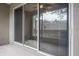 Covered outdoor patio with sliding glass doors, offering a serene view at 3298 Covered Bridge W Dr, Dunedin, FL 34698