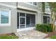 The screened porch has a patterned tile floor and lush shrubbery at 3298 Covered Bridge W Dr, Dunedin, FL 34698