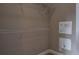 Walk-in closet with white wire shelving and additional electrical panels for various systems at 3298 Covered Bridge W Dr, Dunedin, FL 34698