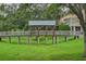 A wooden walking bridge overlooking a scenic view of a green field at 3298 Covered Bridge W Dr, Dunedin, FL 34698
