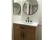 Bathroom vanity with a round mirror, black hardware and stylish sink faucet at 3610 54Th W St # B8, Bradenton, FL 34209