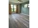 Comfortable bedroom featuring gray wood flooring and view of backyard at 3610 54Th W St # B8, Bradenton, FL 34209