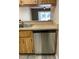 Kitchen featuring stainless steel dishwasher, laminate countertop and wood cabinets at 3610 54Th W St # B8, Bradenton, FL 34209