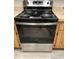 Kitchen showcasing stainless steel stove/oven with wood cabinets at 3610 54Th W St # B8, Bradenton, FL 34209
