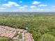 Scenic aerial view of beautiful community with red tile roofs, mature trees, and lush landscaping at 3810 Darston St, Palm Harbor, FL 34685