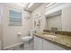Bathroom with shower-tub combo, granite countertop vanity, decor, blind and tiled floors at 3810 Darston St, Palm Harbor, FL 34685