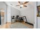 Bedroom with desk, treadmill, ceiling fan, and hardwood floors at 3810 Darston St, Palm Harbor, FL 34685
