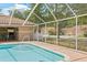Community pool featuring clear water with a nearby bar area and screened enclosure at 3810 Darston St, Palm Harbor, FL 34685