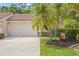 Charming home featuring a tile roof, two-car garage, and well-maintained landscaping at 3810 Darston St, Palm Harbor, FL 34685